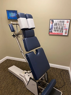 Adjustable chiropractic table in an examination room.